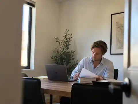 Illustrative image of Trenton Nield reviewing living trust funding paperwork at his desk